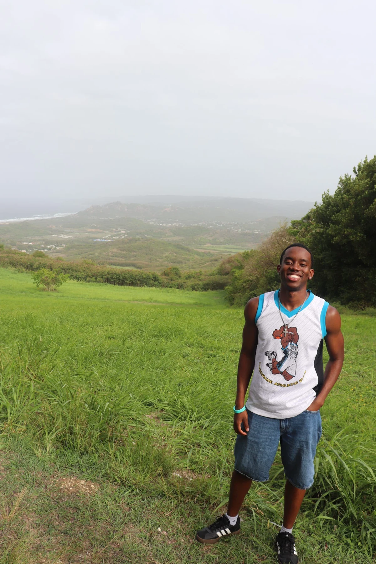 Ladi smiling in a green hillside landscape